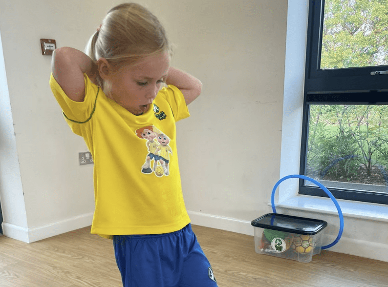 Toddler development. Image shows a toddler in Socatots uniform at the class.