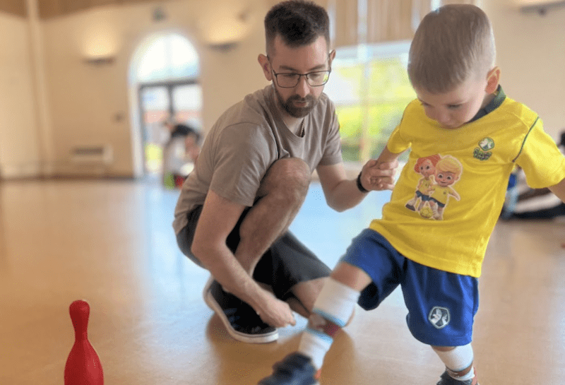 Toddler football club. Image shows a dad and son at a Socatots class.