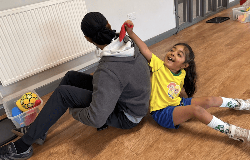 Toddler football classes in Milton Keynes. Image shows a daughter and dad taking part in a Socatots class.