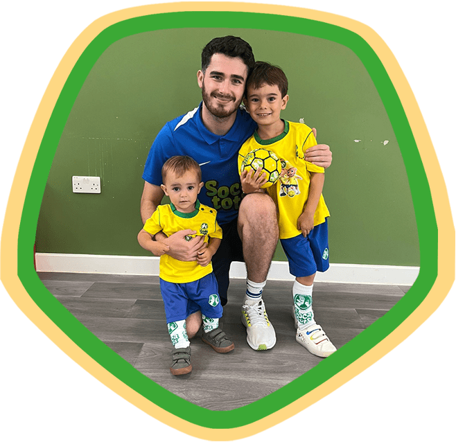 Socatots coach with two Socatots students holding a Socatots ball