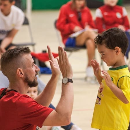 Coach Paul giving Socatots boy a high five