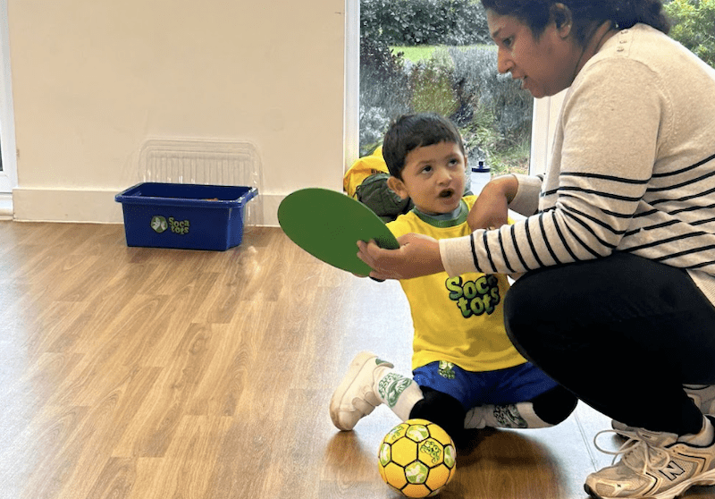 Toddler football classes in Leighton Buzzard. Image shows a mother and child taking part in a Socatots class.