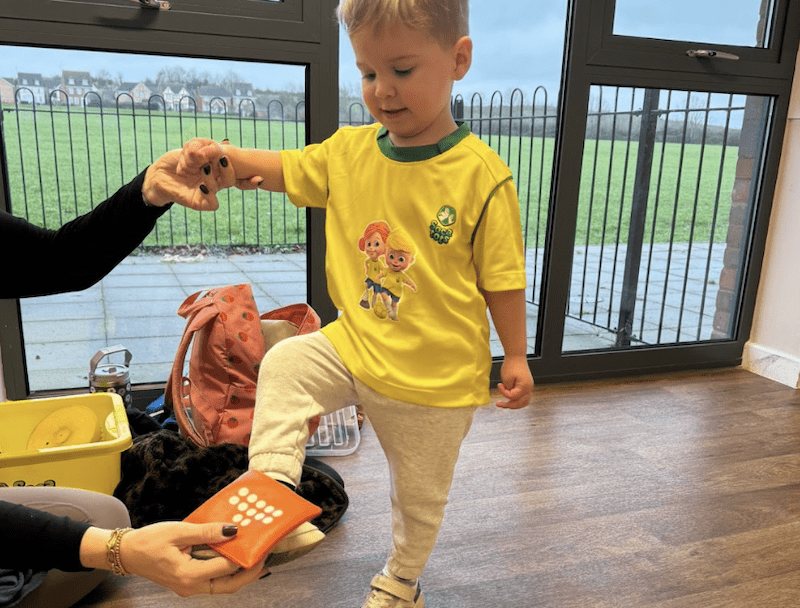 Toddler football classes in Southampton. Image shows a child balancing a bean bag on his foot during a Socatots class.