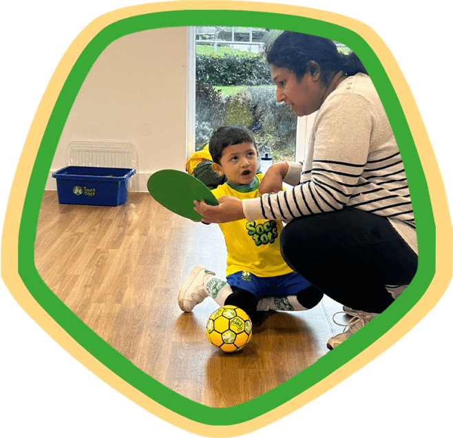 A mother and her child taking part in a Socatots class