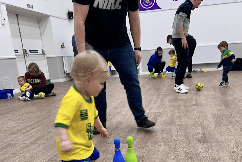Toddler football classes in Selby. Image shows a group of toddlers and parents taking part in their Socatots class. 